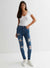 Ladies Blue Ripped Mid Rise Skinny Jeans
